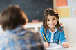 © Tetra Images - Pupils (6-7) learning in classroom, Girl (6-7) looking at camera