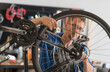 © Tetra Images - Man repairing bike in shop