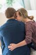 © Tetra Images - Rear view of young couple hugging