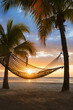© Tetra Images - Hammock on beach at sunset