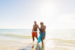 © Tetra Images - Mature couple walking in sea