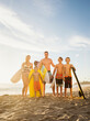 © Tetra Images - Portrait of family with three children (6-7, 10-11, 14-15) with surfboards on beach