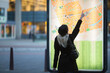 © Tetra Images - Young woman pointing at city map