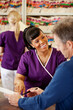 © Sean Locke Photography/Stocksy - Waiting Room: Nurse Laughs At Patient Question