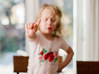 © Meaghan Curry Photography/Stocksy - closeup of a little girl shaking her finger no