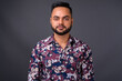 © Ranta Images - Young bearded Indian man against gray background