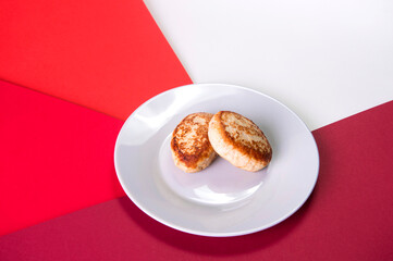 Close up of Two chicken Meatballs served on gray plate. Russian traditional Homemade meat cutlets on colorful abstract red background. Slavic food menu
