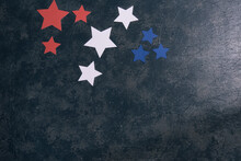 Red, White, And Blue Stars On A Dark Blue And Gray Textured Background.