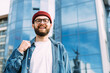 © mykolastock - Fashionable portrait of young happy successful stylish bearded male hipster looking straight into the camera and smiling