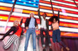 © MyMicrostock/Stocksy - American Friends Having Fun with a USA Flag in Times Square, Manhattan, USA