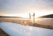 © Hugh Sitton/Stocksy - Couple on beach at sunset.