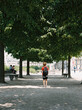 © Kirstin Mckee/Stocksy - Rear view of boy standing under trees in Paris, France