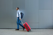 © JELENA JOJIC TOMIC/Stocksy - Businessman with the suitcase walking down the street