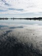 © Jacqui Miller/Stocksy - Morning view across Canning River toward Perth, Western Australia, with cloud reflections on water