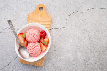 Fototapete - Strawberry  ice cream flavour in white  bowl setup on concrete background . Summer and Sweet menu concept.