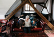 © Beatrix Boros/Stocksy - Grandma and grandchildren reading a book together