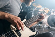 © Ibex.media/Stocksy - Closeup of hands playing electric bass guitar