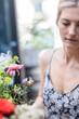 © Lior + Lone/Stocksy - Portrait of young attractive blond woman holding flowers