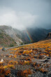 © Luke Mattson/Stocksy - Rainbow And Dark Clouds Over Rocky Mountainside