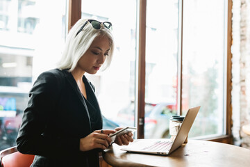 Cool businesswoman sitting at cafe
