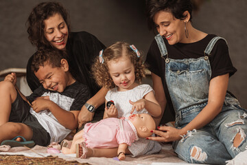 Wall Mural - couple of women having fun with daughter outdoors