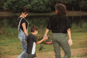 Wall Mural - couple of women walking hand in hand with son