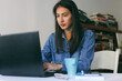 © VeaVea/Stocksy - Beautiful woman working on a laptop in her home