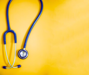 Wall Mural - Top view blue stethoscope on pink background. For check heart or health check up concept