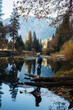 © Jesse Morrow/Stocksy - young woman by beautiful reflection lake in fall mountain trees