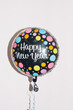 © VeaVea/Stocksy - Happy New Year''balloon in front of a white wall