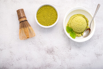 Fototapete - Matcha green tea ice cream with matcha whisk brush  setup on white stone background . Summer and Sweet menu concept.