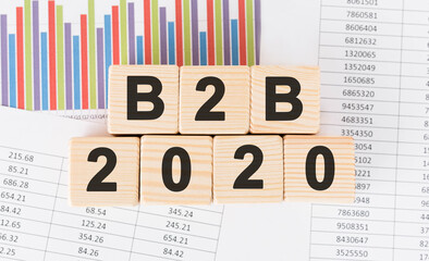 Poster - b2b 2020 word written on wood block. faqs text on table, concept.