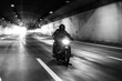 © Akela - from alp to alp/Stocksy - dark rider riding his bike in a tunnel - black and white