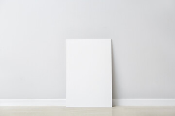 Blank poster near light wall