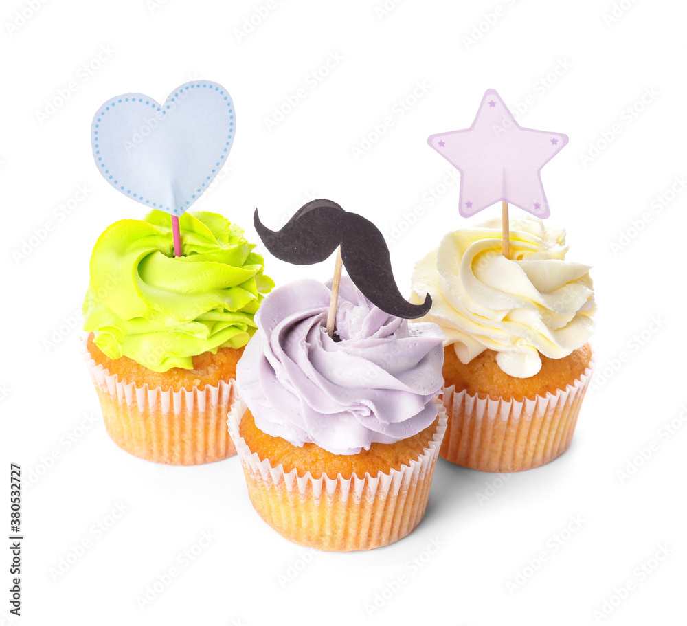 Tasty cupcakes with stylish toppers on white background
