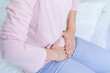 © Ann Patchanan - Gynecology concept. Hands of young woman on stomach as suffer from menstruation cramp, indigestion, gastrointestinal, diarrheas or female diseases problem