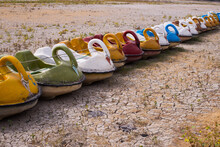 Line Of Paddle Boats On A Dried Out River Bed