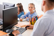 © LIGHTFIELD STUDIOS - Selective focus of schoolgirl looking at teacher during lesson in stem school