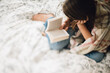 © LÔøΩÔøΩa Jones/Stocksy - young woman reading on her bed