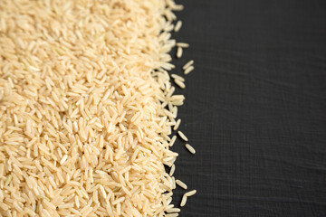 Dry Brown Rice background, side view. Copy space.