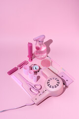 Vintage style layout with pink hairdryer, scissors, bottle, make up and cassette tape on pastel background. Retro fashion aesthetic. Art direction, flat lay, isometric. Minimal 80'st concept.