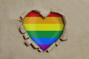 Poster - Heart shaped hole torn through paper, showing LGBT flag