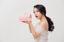 Amazed Young Asian Woman Opening The Pink Gift Box Over White Background.