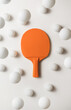 © Audrey Shtecinjo/Stocksy - Orange pIng pong racket and white balls flying