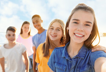 school holidays. group of happy children taking selfie outdoors