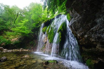 Beautiful waterfall in the summer forest