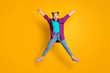 © deagreez - Full length photo of pretty charming crazy teen lady jump up excited good mood rejoicing star figure spread arms legs wear casual plaid shirt sneakers jeans isolated yellow color background