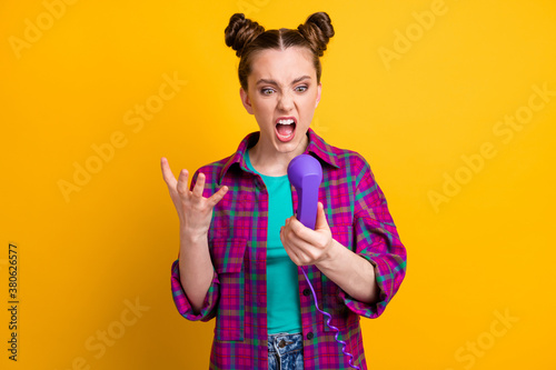 Subscriber is busy. Photo of crazy angry lady two funny buns hold cable telephone handset line bad connection can\'t speak boyfriend wear casual plaid shirt isolated yellow color background