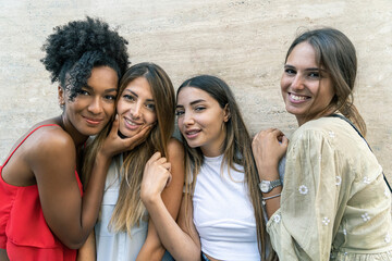 Portrait of women only multiracial young people having fun outdoors. Clean background