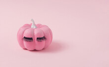 Pink Halloween Pumpkin With Make Up. Minimal Holiday Season Concept Background.